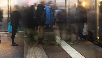 A crowd getting onto a train